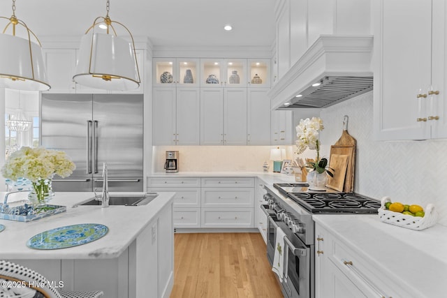 605 Dundee Dr, Wilmington, NC 28405 - kitchen featuring high end appliances, a sink, light countertops, white cabinetry, and recessed lighting