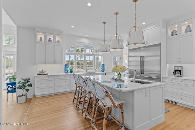 605 Dundee Dr, Wilmington, NC 28405 - kitchen with a sink, built in refrigerator, light countertops, decorative backsplash, and a kitchen island with sink