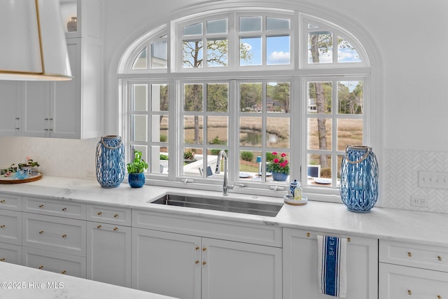 605 Dundee Dr, Wilmington, NC 28405 - kitchen featuring a sink, white cabinetry, and tasteful backsplash