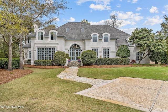 605 Dundee Dr, Wilmington, NC 28405 - french country home featuring a front yard, stucco siding, and french doors