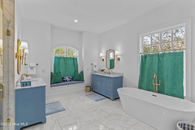 605 Dundee Dr, Wilmington, NC 28405 - full bathroom featuring marble look tiles, vanity, a soaking tub, a shower with door, and baseboards