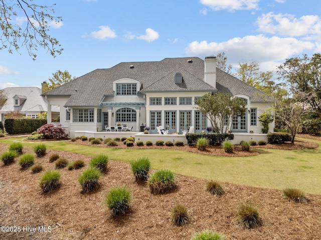 605 Dundee Dr, Wilmington, NC 28405 - rear view of house featuring french doors, a patio area, a lawn, and a chimney