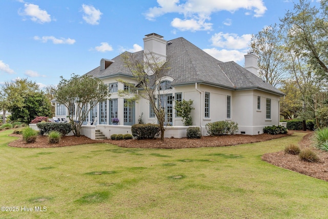 605 Dundee Dr, Wilmington, NC 28405 - rear view of property with a chimney, stucco siding, and a yard