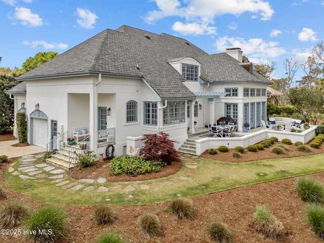 605 Dundee Dr, Wilmington, NC 28405 - rear view of house with a chimney, stucco siding, outdoor dining area, and a pergola