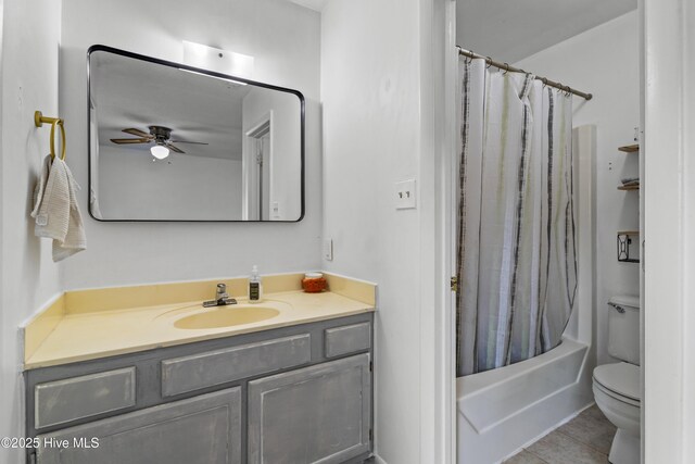 bathroom featuring vanity, toilet, tile patterned floors, shower / bath combo with shower curtain, and a ceiling fan