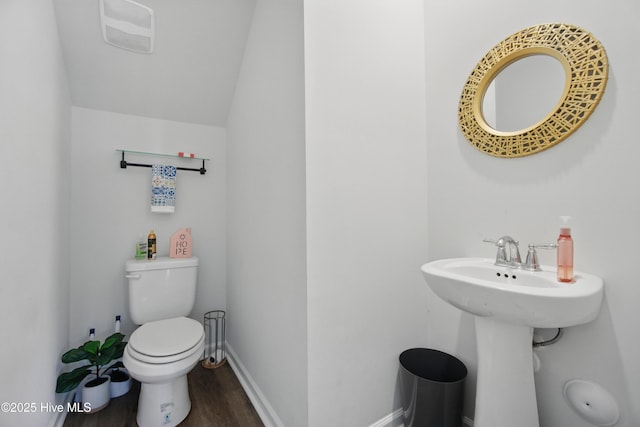 1550 Murre Ct SE, Bolivia, NC 28422 - half bath featuring wood finished floors, toilet, baseboards, vaulted ceiling, and a sink