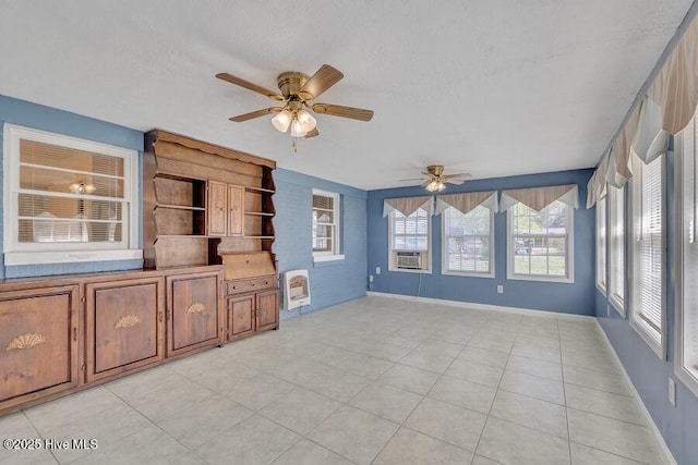 1317 Old Grantham Rd, Goldsboro, NC 27530 - unfurnished living room with a ceiling fan, cooling unit, a textured ceiling, heating unit, and light tile patterned floors