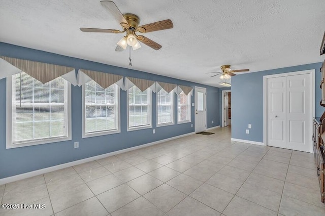 1317 Old Grantham Rd, Goldsboro, NC 27530 - empty room with ceiling fan, light tile patterned flooring, and a textured ceiling