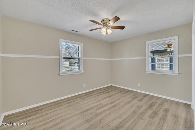 1317 Old Grantham Rd, Goldsboro, NC 27530 - unfurnished room with wood finished floors, a textured ceiling, and a ceiling fan