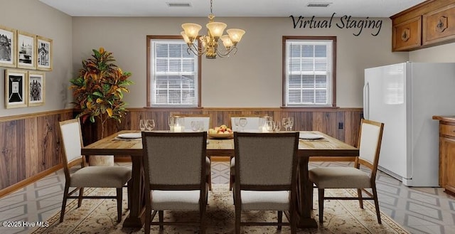 1317 Old Grantham Rd, Goldsboro, NC 27530 - dining area with light floors, a chandelier, a wainscoted wall, healthy amount of natural light, and wood walls