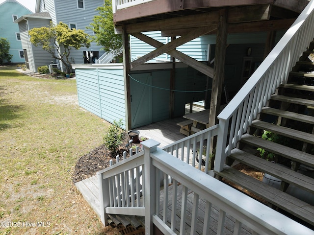 8713 Emerald Plantation Rd, Emerald Isle, NC 28594 - view of home's exterior featuring stairs, a lawn, and a deck