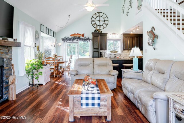 8713 Emerald Plantation Rd, Emerald Isle, NC 28594 - living room with high vaulted ceiling, dark wood-type flooring, ceiling fan, a fireplace, and stairway