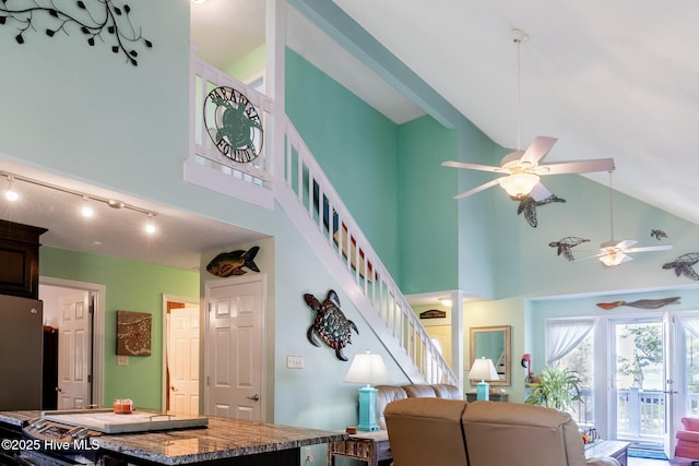 8713 Emerald Plantation Rd, Emerald Isle, NC 28594 - living room with ceiling fan, high vaulted ceiling, and stairway