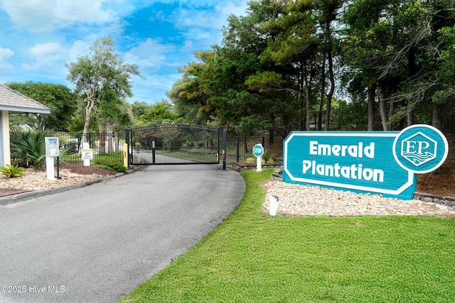 8713 Emerald Plantation Rd, Emerald Isle, NC 28594 - view of asphalt street featuring a gate and a gated entry