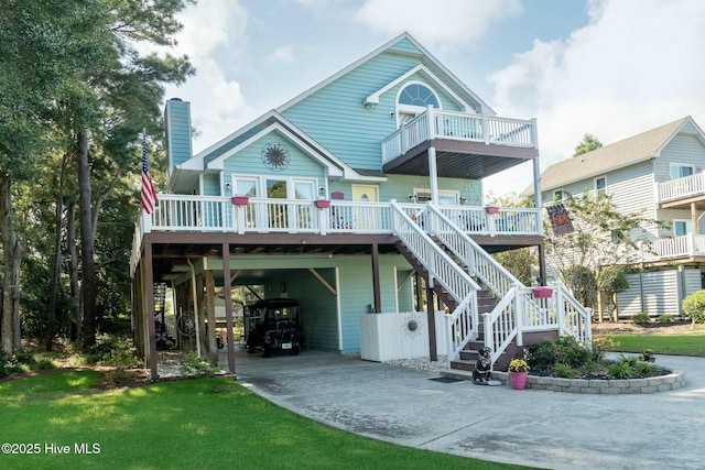 8713 Emerald Plantation Rd, Emerald Isle, NC 28594 - back of house with a carport, concrete driveway, a balcony, and a chimney