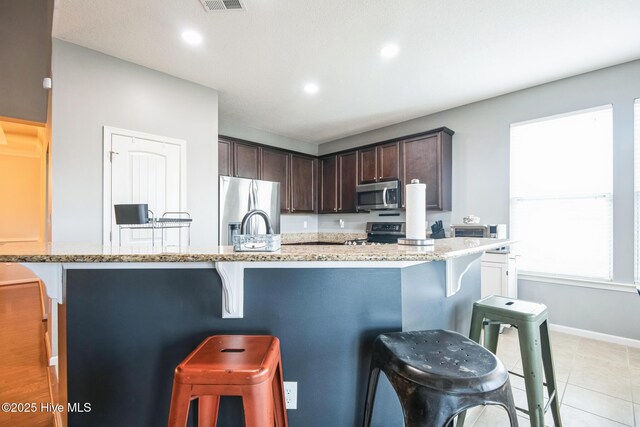 117 NW River Dr, Moyock, NC 27958 - kitchen with recessed lighting, a textured ceiling, appliances with stainless steel finishes, and a breakfast bar