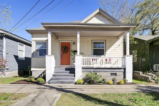 bungalow-style house featuring covered porch and a shingled roof