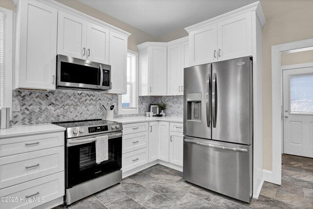 kitchen featuring white cabinetry, light countertops, tasteful backsplash, and stainless steel appliances