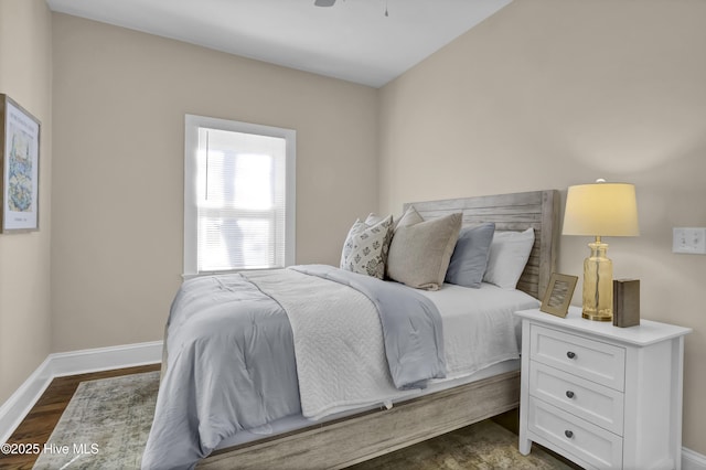bedroom featuring dark wood-type flooring and baseboards