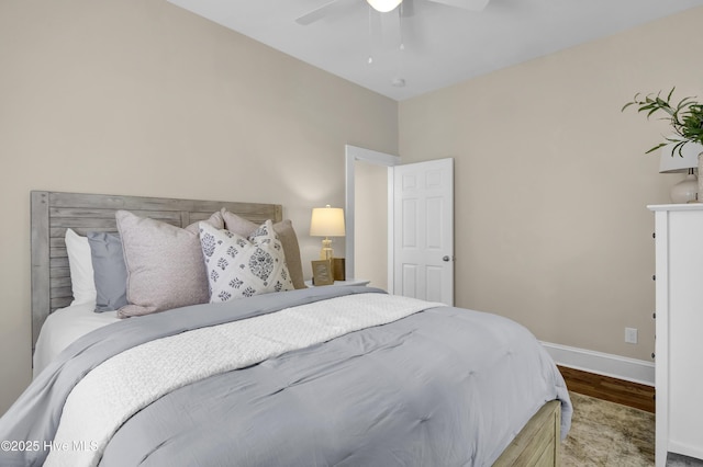 bedroom with a ceiling fan, baseboards, and wood finished floors