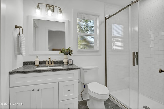 bathroom with toilet, vanity, and a shower stall