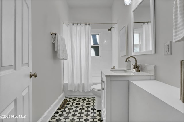 full bathroom with toilet, vanity, baseboards, and shower / tub combo with curtain