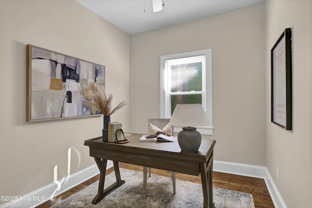 home office featuring a ceiling fan, baseboards, and wood finished floors