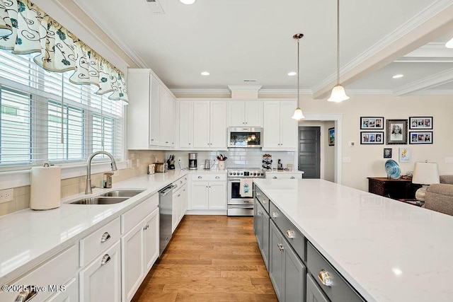 kitchen with a sink, gray cabinets, white cabinetry, and stainless steel appliances