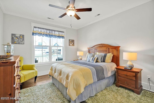 bedroom featuring crown molding, baseboards, and visible vents