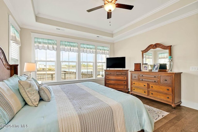 bedroom featuring crown molding, multiple windows, visible vents, and dark wood-type flooring