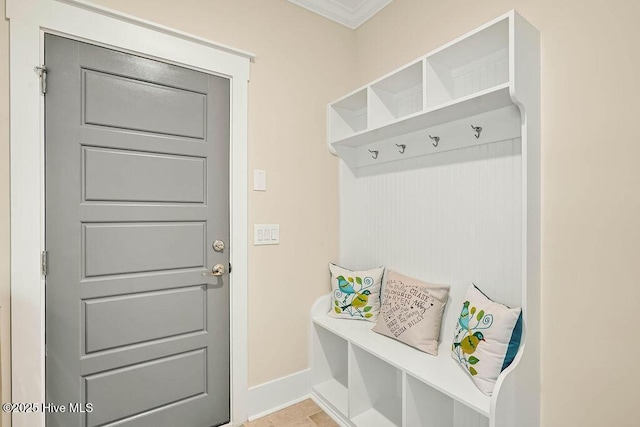 mudroom featuring crown molding and baseboards