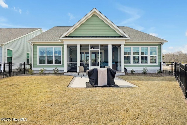 back of property with a sunroom, a fenced backyard, a patio area, and a yard