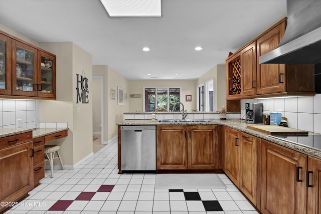 kitchen with a sink, wall chimney exhaust hood, dishwasher, a peninsula, and brown cabinetry