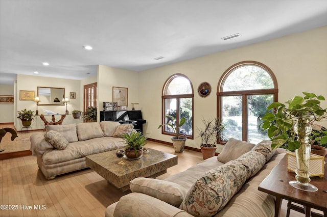 living area with light wood-type flooring, recessed lighting, baseboards, and visible vents