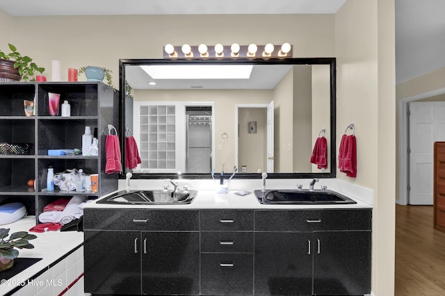 bathroom with a sink and wood finished floors