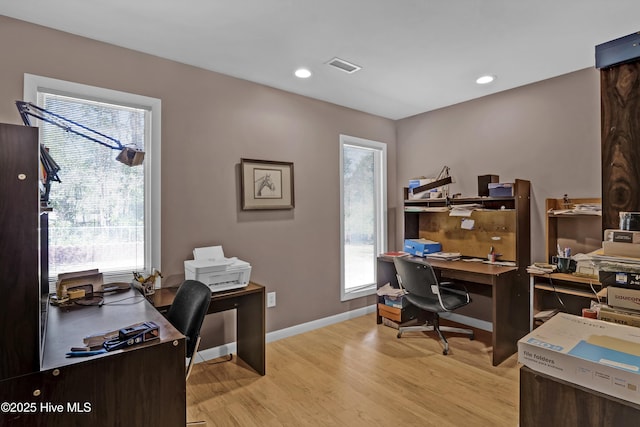 office space with baseboards, recessed lighting, visible vents, and light wood-style floors