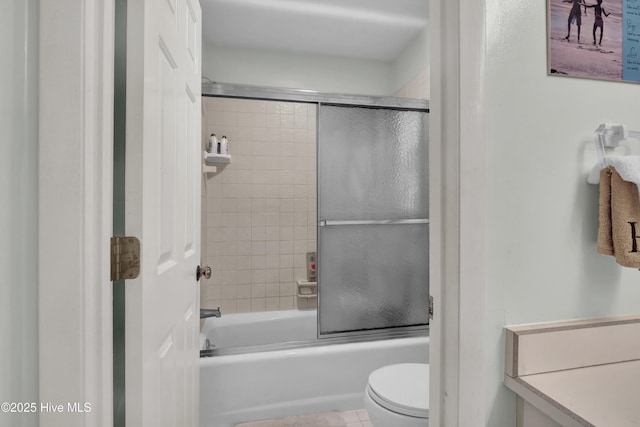bathroom with toilet and bath / shower combo with glass door