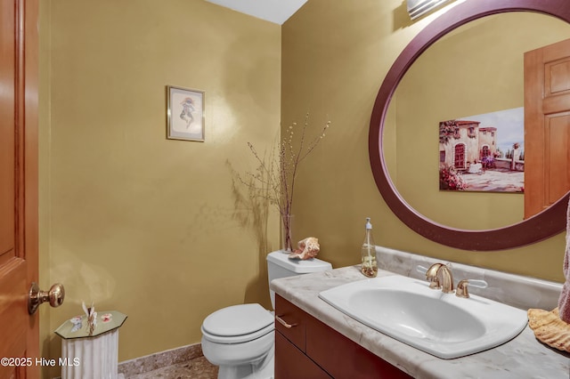 half bath featuring toilet and vanity