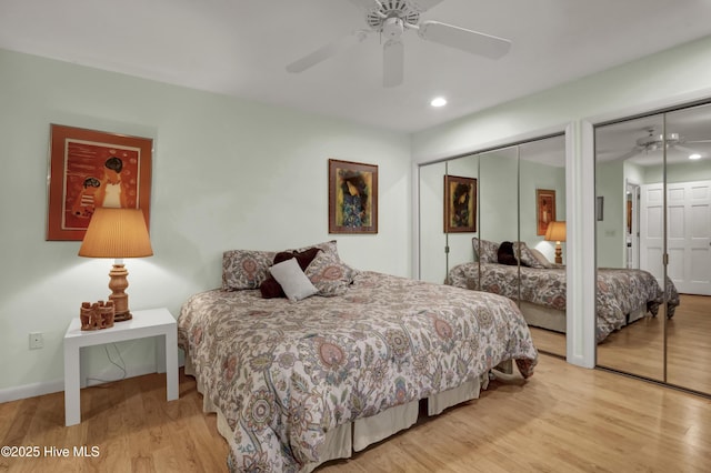 bedroom featuring ceiling fan, recessed lighting, multiple closets, and wood finished floors