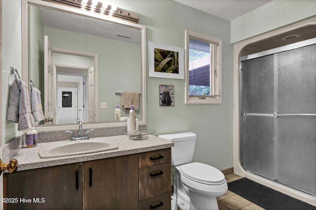 full bathroom featuring vanity, toilet, tile patterned floors, a stall shower, and visible vents