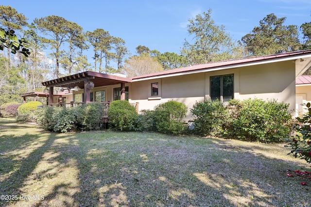 exterior space with a lawn and stucco siding