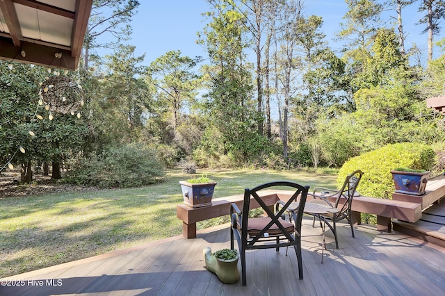 wooden deck featuring a lawn