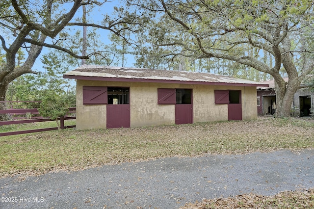view of outbuilding with an outbuilding and fence
