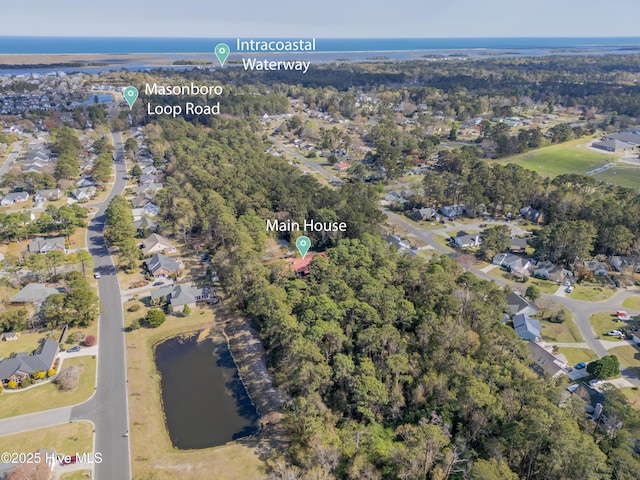 drone / aerial view featuring a residential view and a water view