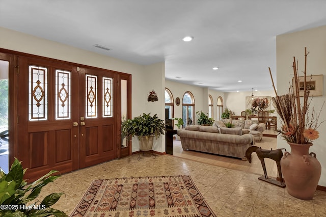 entryway with baseboards, visible vents, and recessed lighting