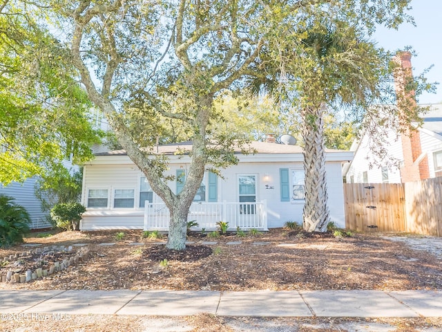 307 Fayetteville Ave, Carolina Beach, NC 28428 - view of front facade with covered porch and fence
