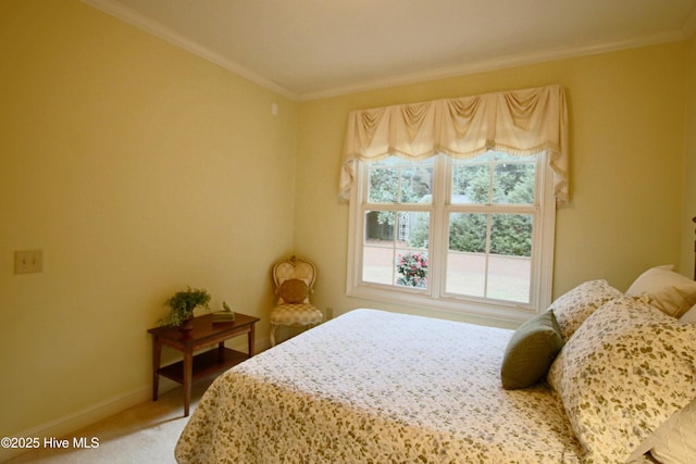 bedroom featuring baseboards, ornamental molding, and carpet floors