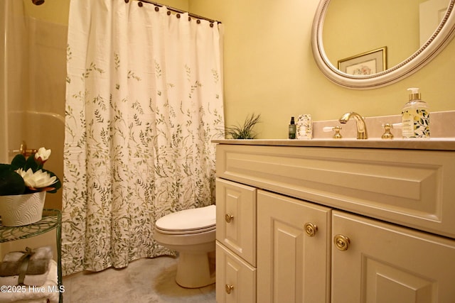 bathroom featuring toilet, curtained shower, and vanity