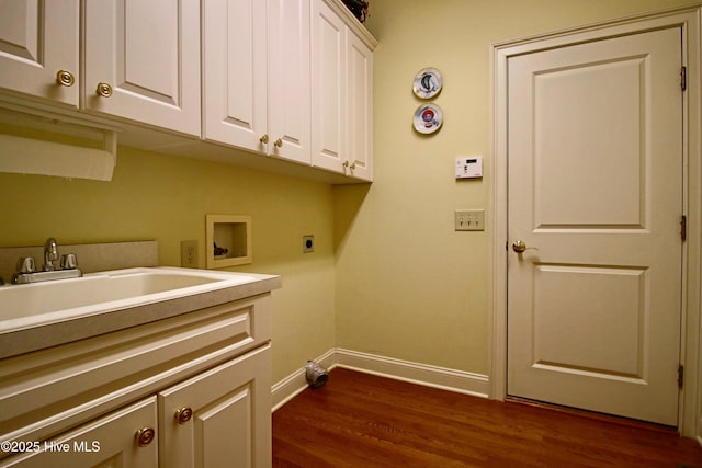 laundry area with dark wood finished floors, electric dryer hookup, cabinet space, washer hookup, and baseboards