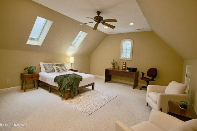 bedroom featuring lofted ceiling with skylight, ceiling fan, carpet flooring, and baseboards